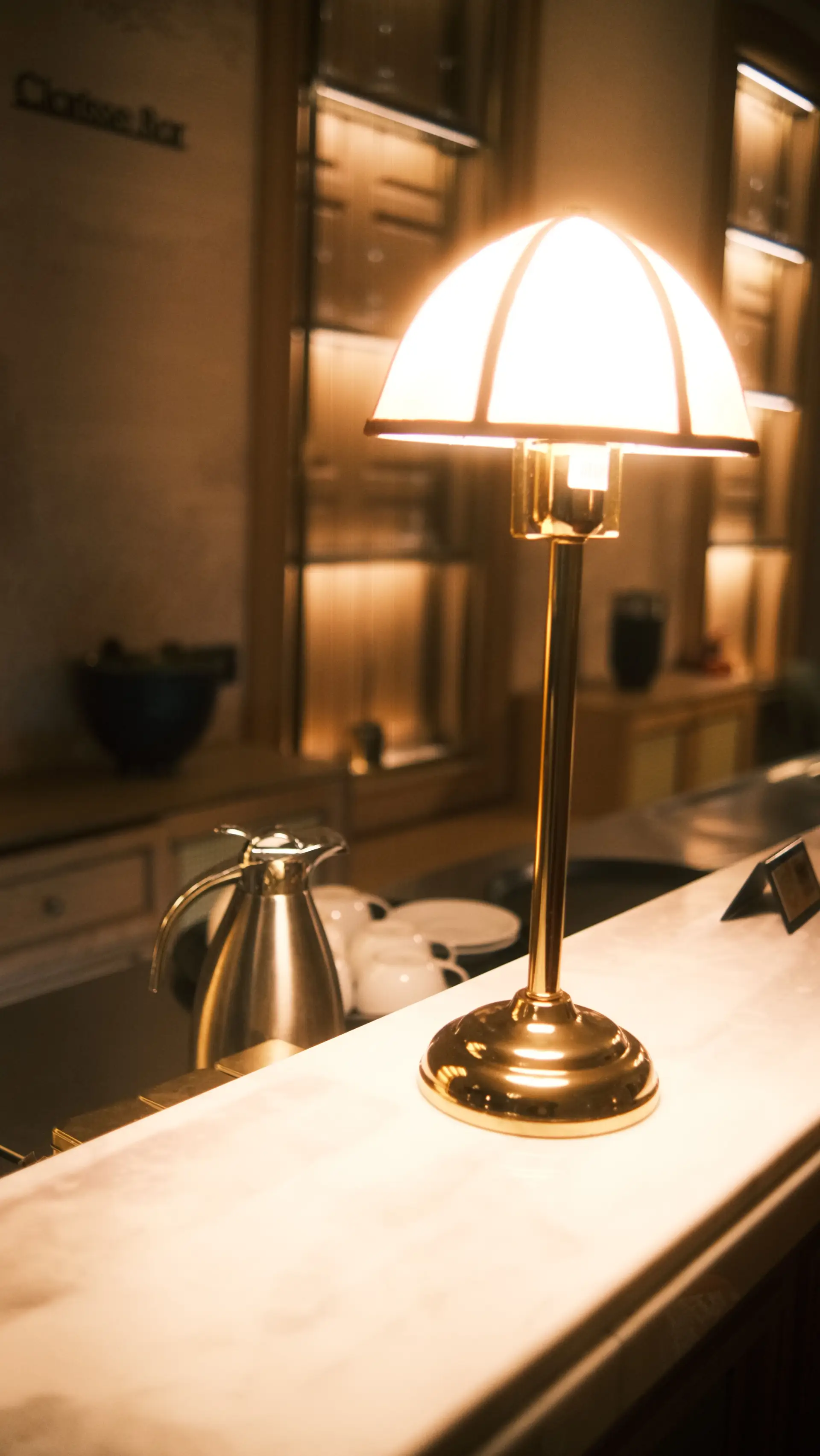 Warmly lit brass lamp on a counter