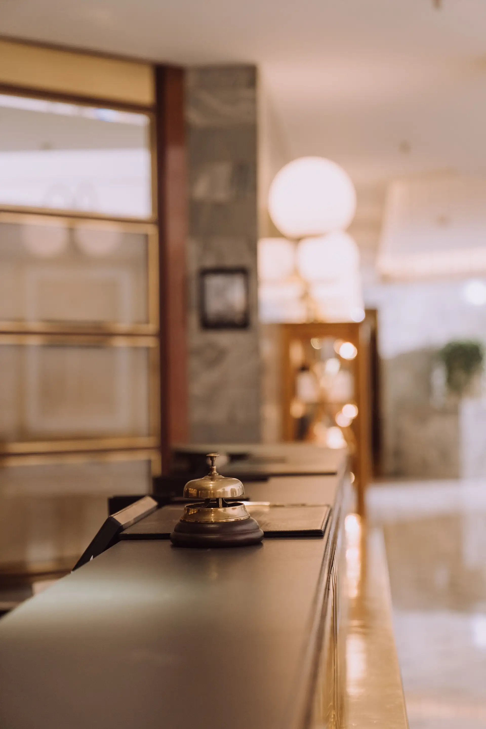 Elegant hotel reception desk with a classic bell